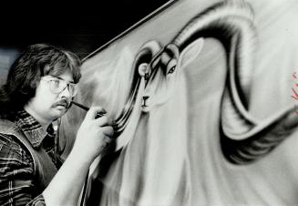 George Hodgson puts the final touches on a mural
