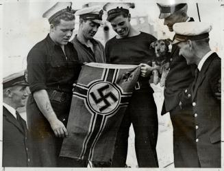 Crew Examines ensign of the captured I-boat