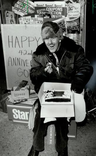 Hot sweet it is: Gord Fry, 56, grins as he samples a cake given him to celebrate his 42nd anniversary as a news vendor