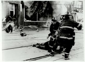 Colin McConnell, won the Toronto Firefighters Association award for this photograph (above) concerning a blaze at a Parliament St. building in which six firemen barely escaped with their lives