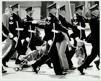 Bull's feature photograph depicted the humorous quandary of a mother and son caught up among marching policemen during a parade at Nathan Phillips Square last May