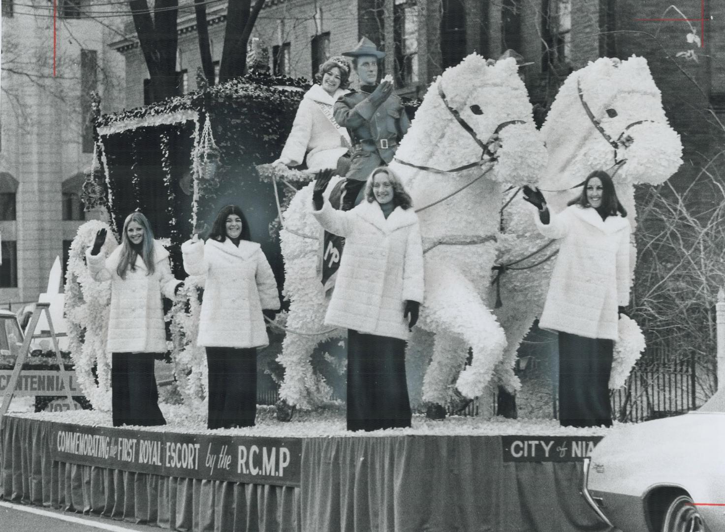 Dressed warmly, despite the mild weather, are these participants o the City of Niagara float which took part in today's Grey Cup parade through down-t(...)