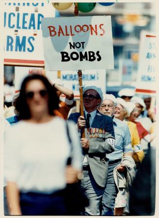 Veteran carries placard denouncing bombs