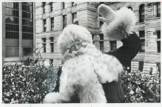 Santa Claus waves to cheering crowds as he passes old city hall in the parade Saturday, when hundreds of thousands of children and adults lined the ro(...)