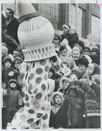 Meeting the kids, one of many clowns in this year's Santa Claus parade shakes hands with youngsters at the curb as he escorts Santa along Saturday's 6(...)