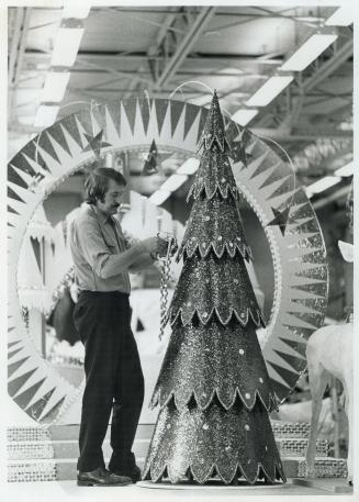 Karl Berzins works on a Christmas Tree