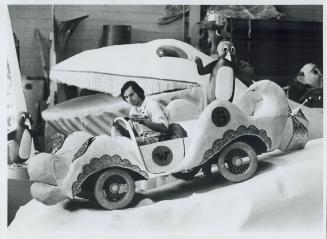 Pic 3. Fred Kay sits in one of the whacky races cars and put the finishing touches to his Penguin