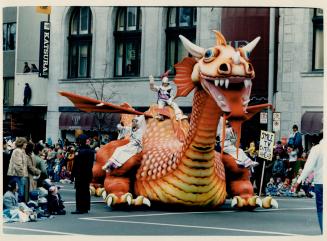 Breathing fire: A 50-foot dragon with flapping wings, claws out-stretched and simulated flames belching from its toothy maw drew rave reviews at the annual Santa Claus Parade yesterday