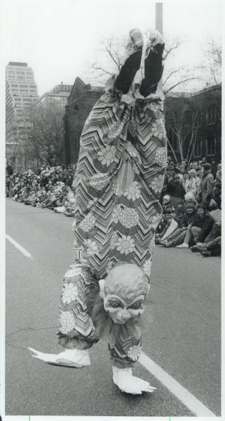 Erin Thatcher's letter, above, was for Santa but other paraders, like the clown at right still manage to catch the 3-year-old's eye