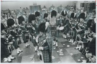 Not even this pipe band on the floor of the Toronto Stock Exchange yesterday was enough to stop business as usual-although the brisk trading pace did (...)