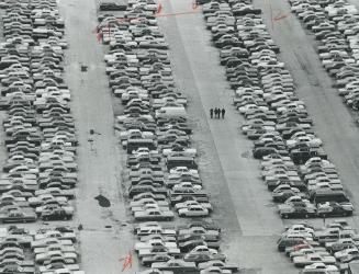 Now you see 'em, now you don't, it took two hours of a busy business day to transform the packed downtown parking lot above to the tranquil scene below