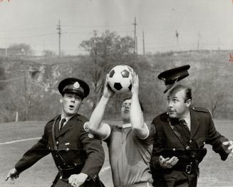 Officer losing his cap was Bob Olsen's winning picture, He took the best feature photograph during a police soccer practice May 6