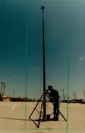Full picture: Inventor Joseph Cacic demonstrates his telescopic tripod by focusing the camera on top with a video monitor