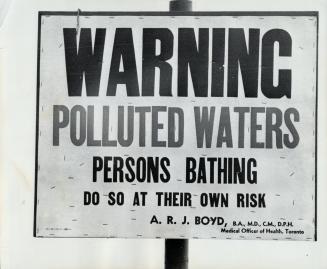 Warning Polluted Waters Persons Bathing Do So At Their Own Risk, Pollution Warning Marking a beach in Metro