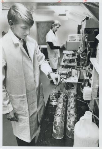 Lab technicians Keith Austen (foreground) and Harry Alkema test Lake Ontario water samples for nutrients aboard the motor vessel Martin Karlsen, a floating pollution research laboratory
