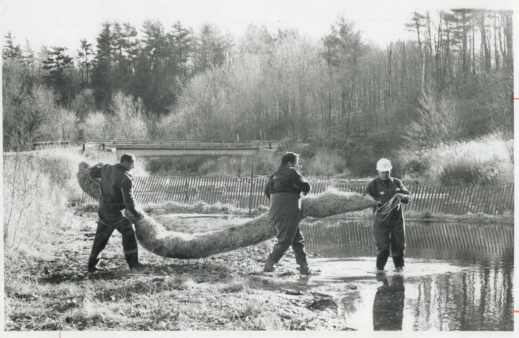 Observers were recruited to don hip waders and place booms across Sixteen Mile Creek during demonstration