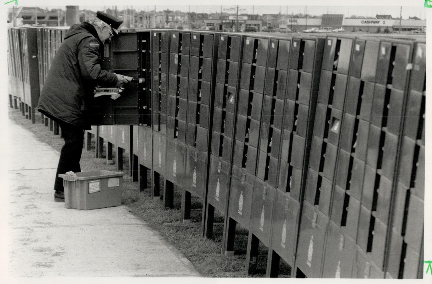 Mailboxes causing super problems, Postman George Lumb delivers mail to this row of green Canada Post mailboxes on Westney Rd. in Ajax, which will even(...)