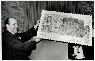 In photo at right, Sylvain Cloutier, chairman of the board of Canada Post unveils the new stamp that will commemorate the first post office. The build(...)