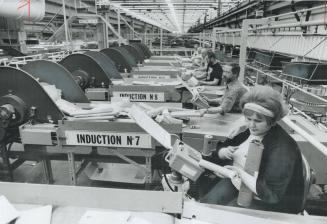 Janice McCrickard, foreground, is one of a small army of workers at the massive South Central postal station on Eastern Ave