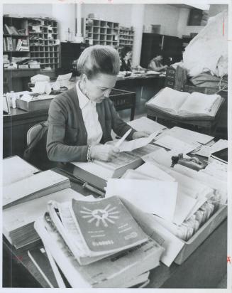 Reading other people's mail is all in the day's work for Marion Hubel, one of 21 persons in the Undeliverable Mail office at the Front Street Post Off(...)