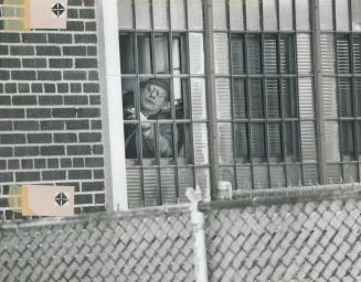 10-By-12-Inch hole in bars through which eight convicts escaped - one was recaptured - from Mimico Correctional Centre is inspected by a prison offici(...)