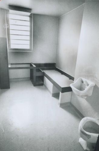 Pastel-painted cell in the new jail has a clothes closet, desk and night table built in