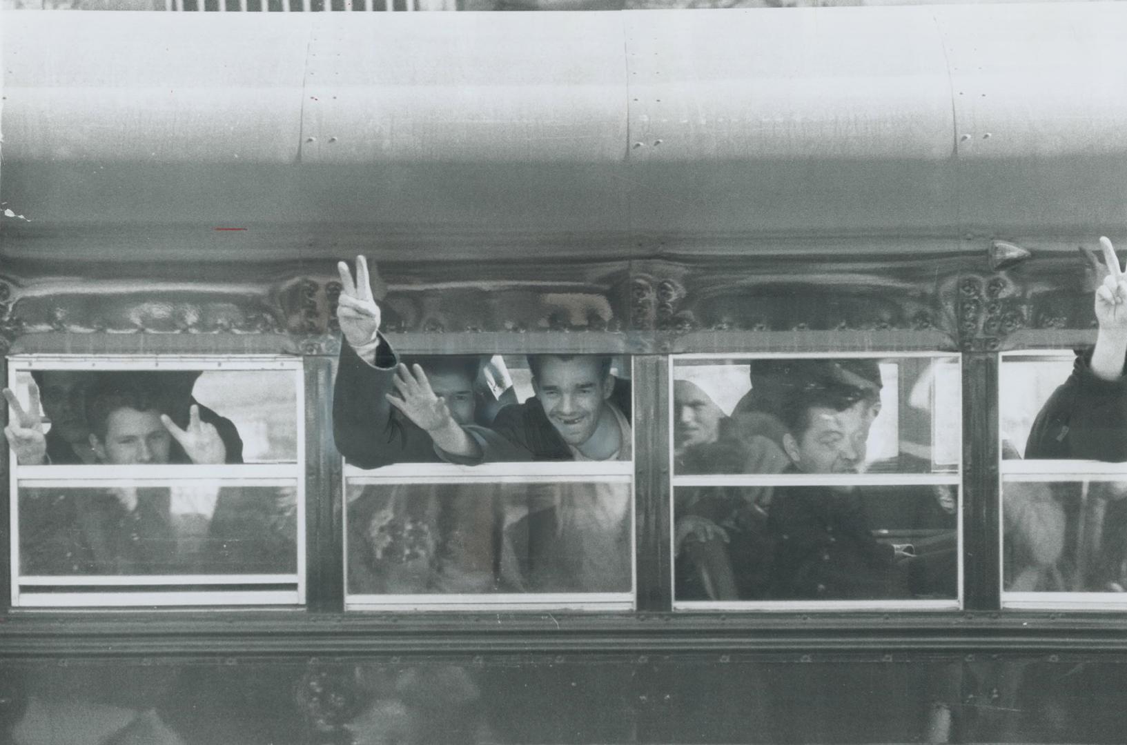 On way to new prisons after a four-day convict rebellion at Kingston penitentiary inmates wave and give victory sign as they are transferred by bus yesterday