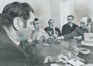 Kingston penitentiary warden. Arthur Jarvis (left) sits quietly listening to group of inmates who are acting as spokesmen for 500 rebellious convicts (...)