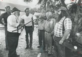 King Maury, with stick, talks with some of his subjects, the hoboes of the United States