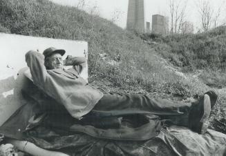 Joe Papineau relaxes on top of his warm steampipe in the rail yards near CN Tower