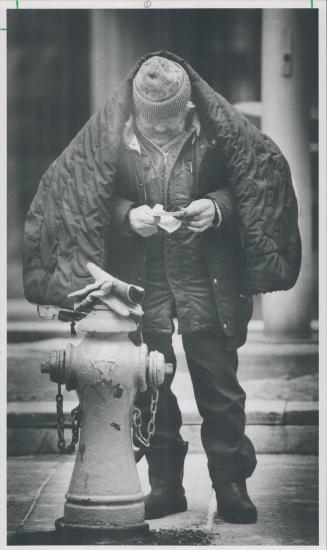 Mannix, who says he has lived on the streets for 20 years, stops to count his money, above left, before buying fries at a chip wagon