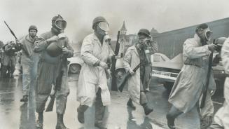 Saving in to crush riot, National Guardsmen wearing gas masks prepare to storm Cellblock D, the stronghold of the rebellious convicts at Attica, N.Y.,(...)