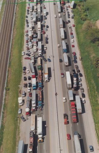 Hell highway: Truckers protesting high taxes join in a mass to plug up Highway 401 near Ajax yesterday, adding hours to the trip home for commuters