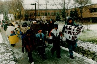 Signs of frustration: Parents and their children picket the York Region District School Board's offices in the snow yesterday, demanding the lockout of 3,214 public elementary teachers be lifted