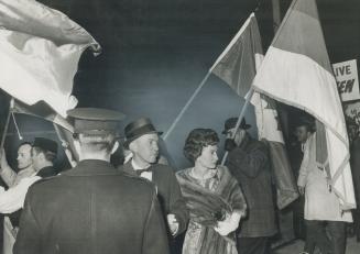 Two innocent bystanders, Metro Chairman William Allen and wife leave Yugoslav consulate on Spadina Rd