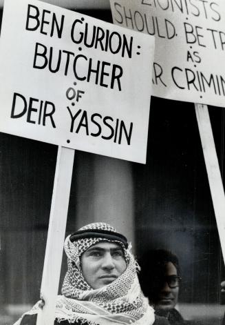 Sign carried by Arab demonstrator outside Royal York last night referes to an alleged slaughter of Arabs at the village of Deir Yassin during the 1948 fighting