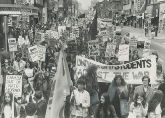The anti-war demonstrators pictured above march down Yonge St