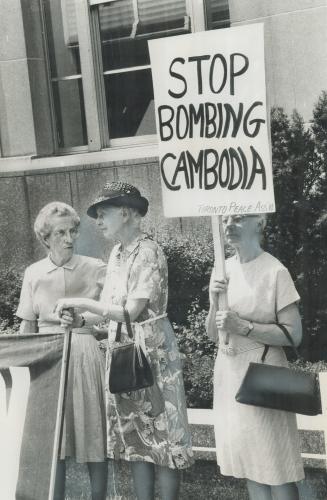 March to protest bombing, Helen Burpe carries a Stop Bombing Cambodia sign outside the United States consulate yesterday with other members of the Toronto Association for Peace