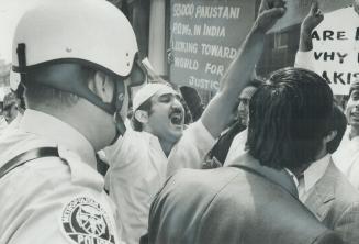 A protester leads other demonstrators in a chant yesterday as they wait outside the Royal York Hotel for the arrival of Indian Prime Minister Indira G(...)