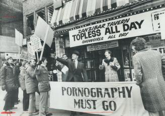 Demonstrating against pornography, 15 marchers led by David Decker of Vancouver (right) stopped outside the Yonge St
