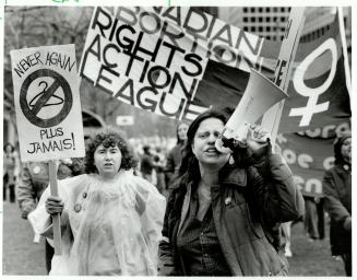 Bad old days: A pro-choice marcher's sign opposes a return to the days of illegal, often amateur abortions, symbolized by the coat-hanger with which they were sometimes performed