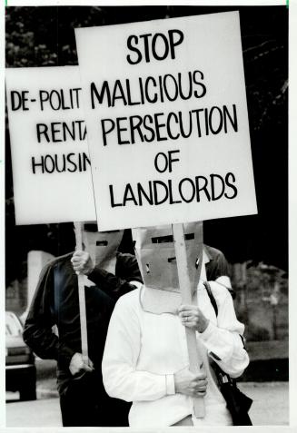 Landlords don brown bag disguise, Members of the Landlord Survival Action Group, who claim to represent small landlords, wore paper bags over their he(...)