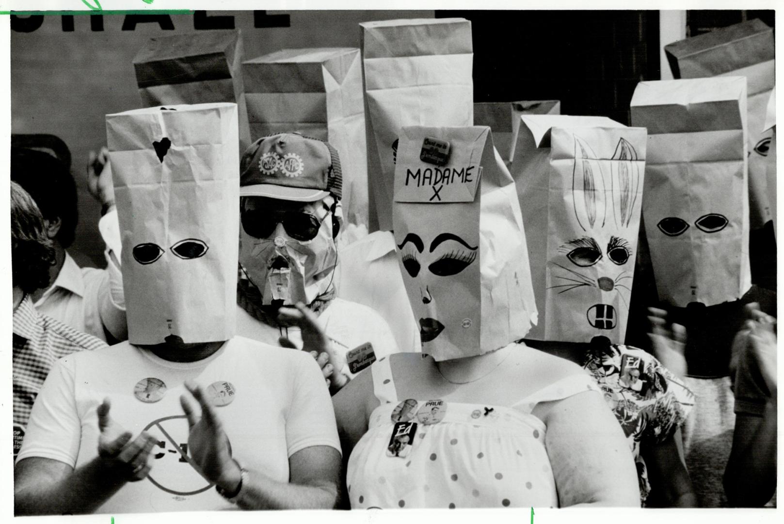Bag protest: A group of federal government employees, some wearing paper bags, demonstrated yesterday against a law that bans civil servants from campaigning in elections