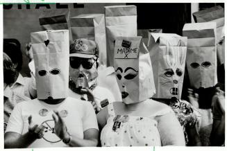 Bag protest: A group of federal government employees, some wearing paper bags, demonstrated yesterday against a law that bans civil servants from campaigning in elections