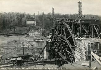 Historic photo from Thursday, April 13, 1916 - Pouring cement for the piers of the Bloor Street Viaduct under construction, west from Pier A in Don River