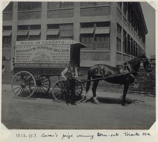 Man stands in front of horse-drawn wagon that says &quot;Made in Toronto, Cowan's Maple Buds .. ...