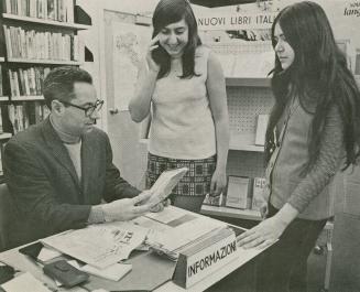 Three people in a library office