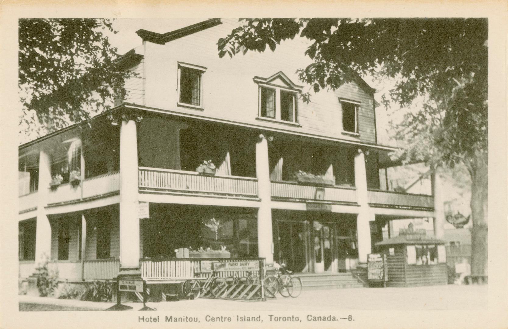 Photo of the front of three storey hotel with large balconies on first and second floors. 