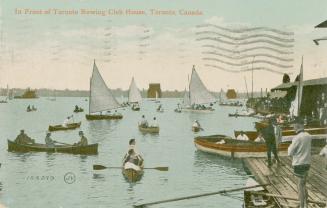Colourized picture of row boats and sailboats on a lake in front of a boathouse. 