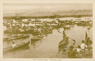 Sepia toned picture of a large number of people in canoes on lake.